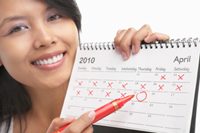 Woman with red felt tip pen and calendar